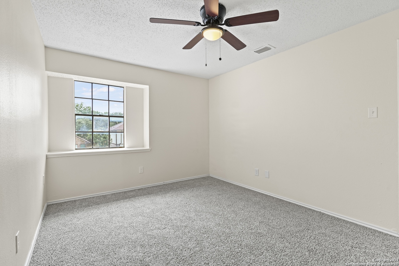 6403 Gray Ridge San Antonio, TX 78233 - Photo 36 of 50 an empty room with windows and fan