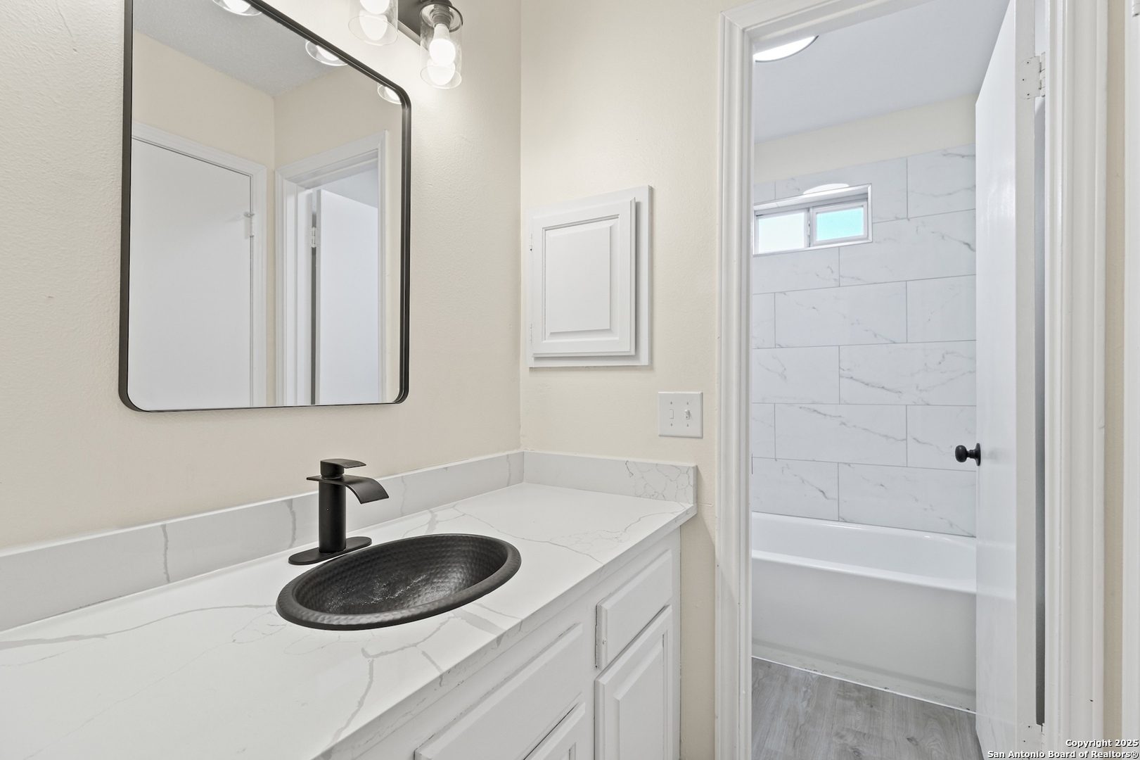 6403 Gray Ridge San Antonio, TX 78233 - Photo 38 of 50 a bathroom with a granite countertop sink and a mirror