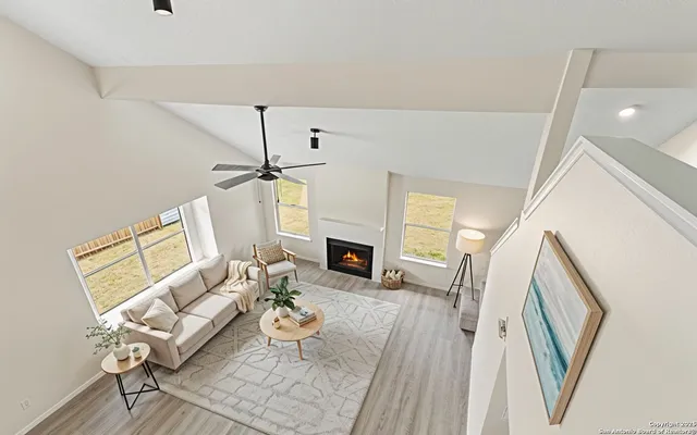 a living room with furniture a fireplace and a flat screen tv