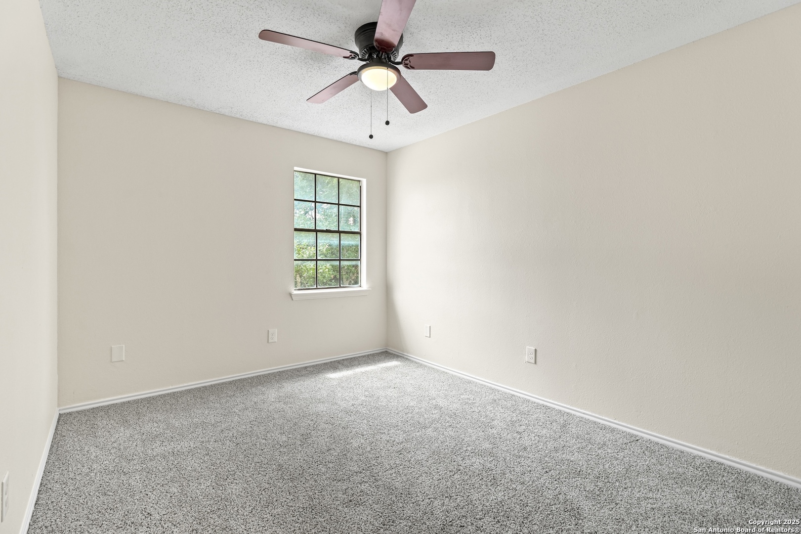 6403 Gray Ridge San Antonio, TX 78233 - Photo 42 of 50 an empty room with a window and a fan