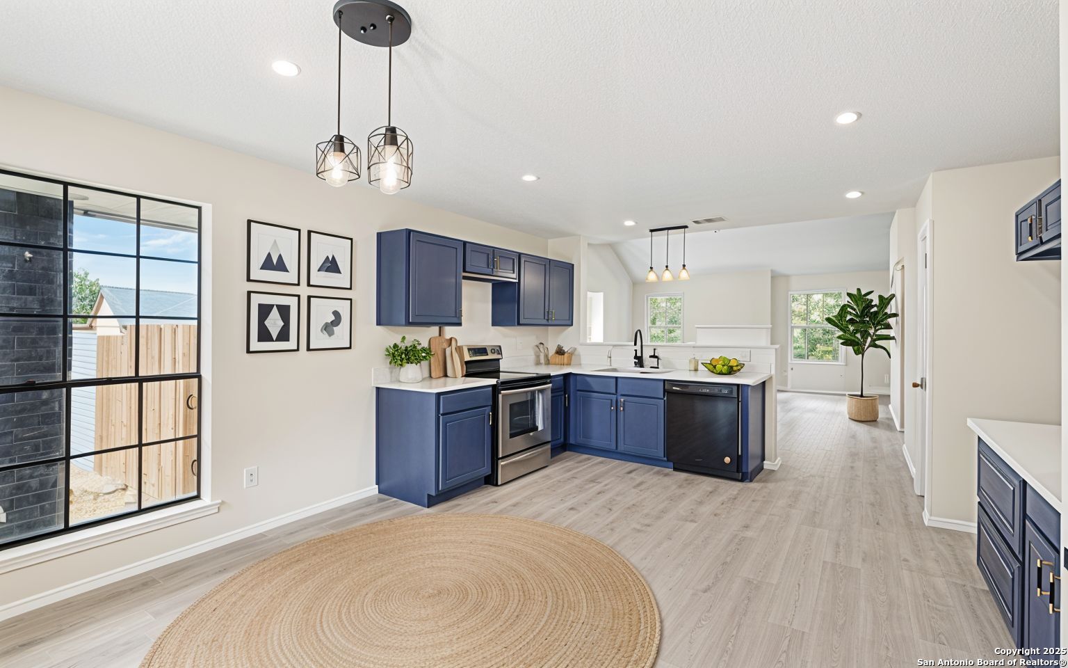 6403 Gray Ridge San Antonio, TX 78233 - Photo 6 of 50 a large kitchen with stainless steel appliances kitchen island granite countertop a large island in the center