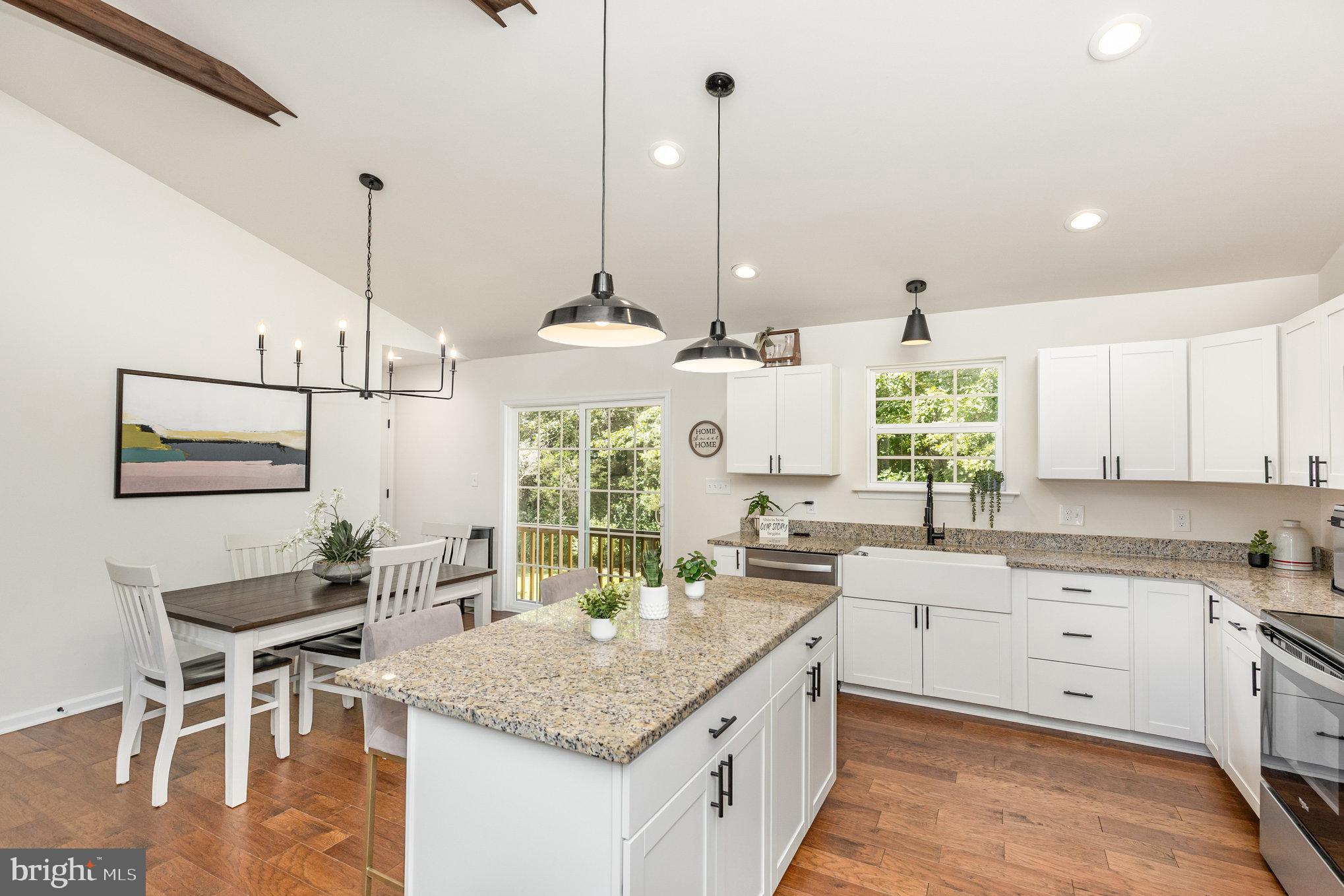 5224 Pendleton Farm Road Bumpass, VA 23024 - Photo 11 of 31 a kitchen with stainless steel appliances granite countertop a sink a stove and a wooden floors