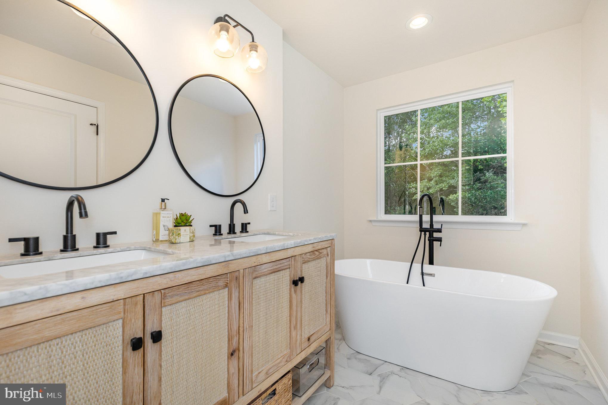 5224 Pendleton Farm Road Bumpass, VA 23024 - Photo 15 of 31 a bathroom with a double vanity sink and a window