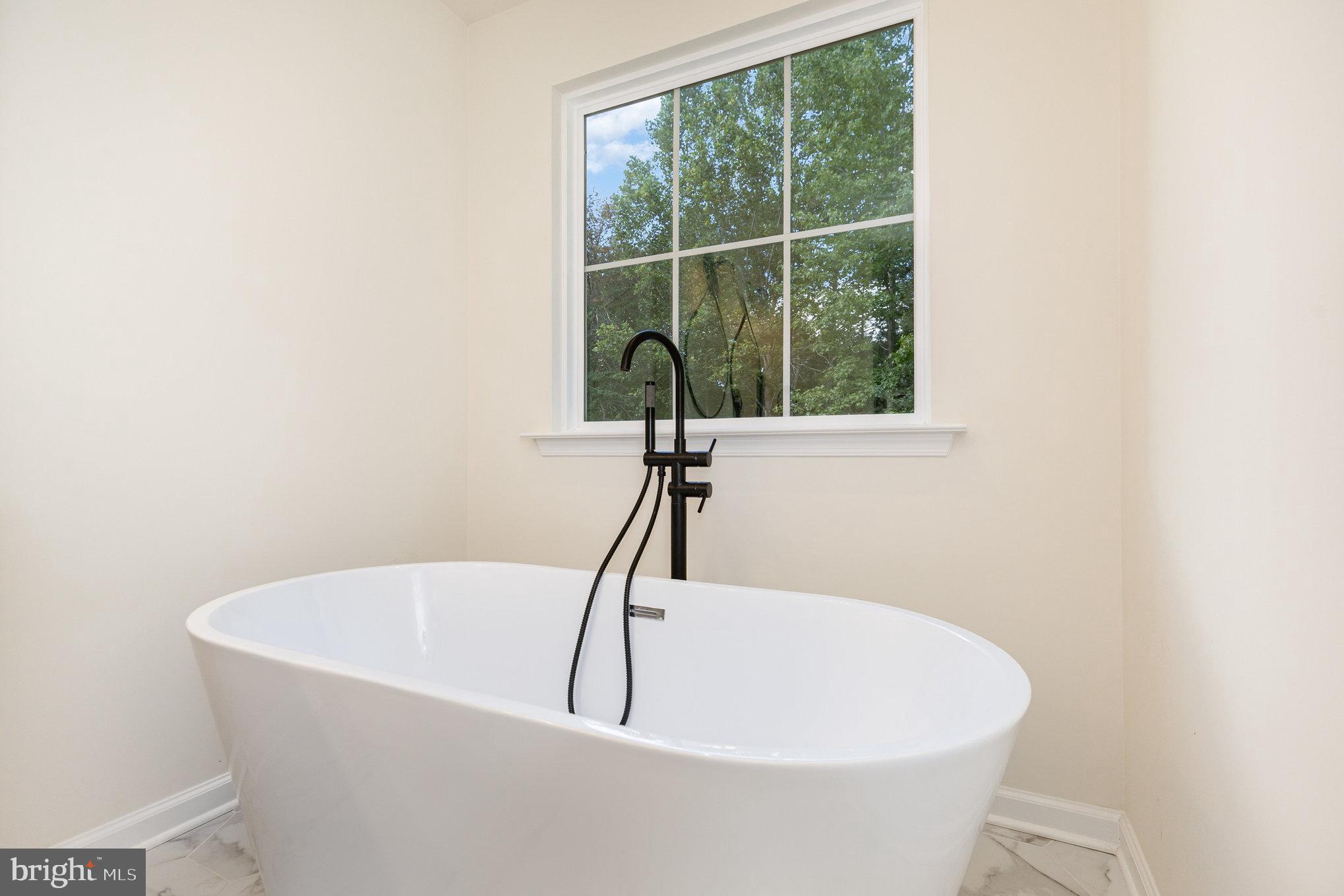 5224 Pendleton Farm Road Bumpass, VA 23024 - Photo 18 of 31 a white bath tub sitting next to a window