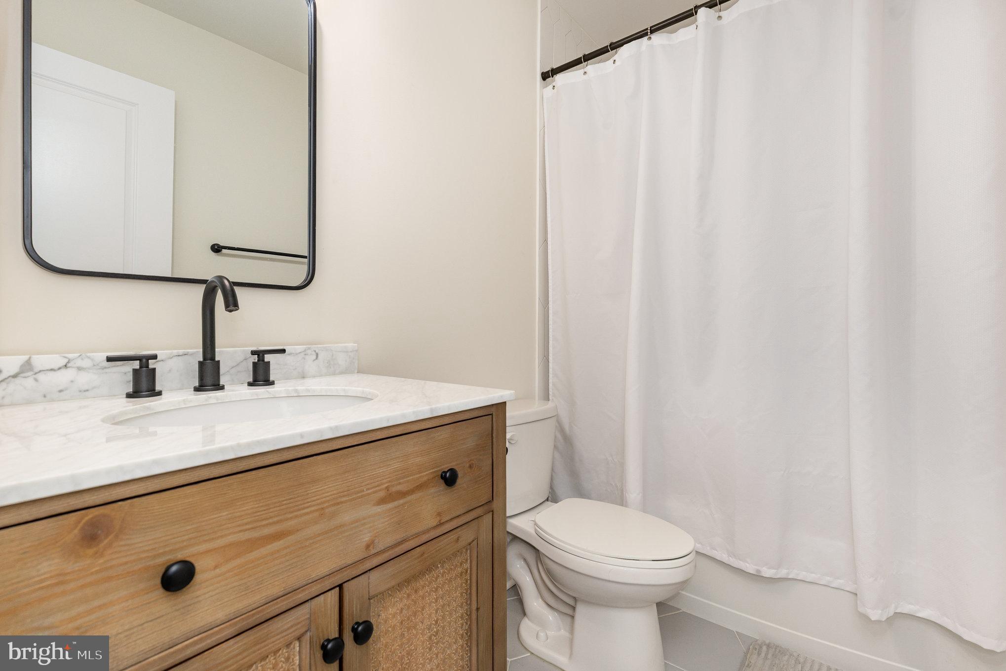5224 Pendleton Farm Road Bumpass, VA 23024 - Photo 21 of 31 a bathroom with a sink vanity mirror and toilet