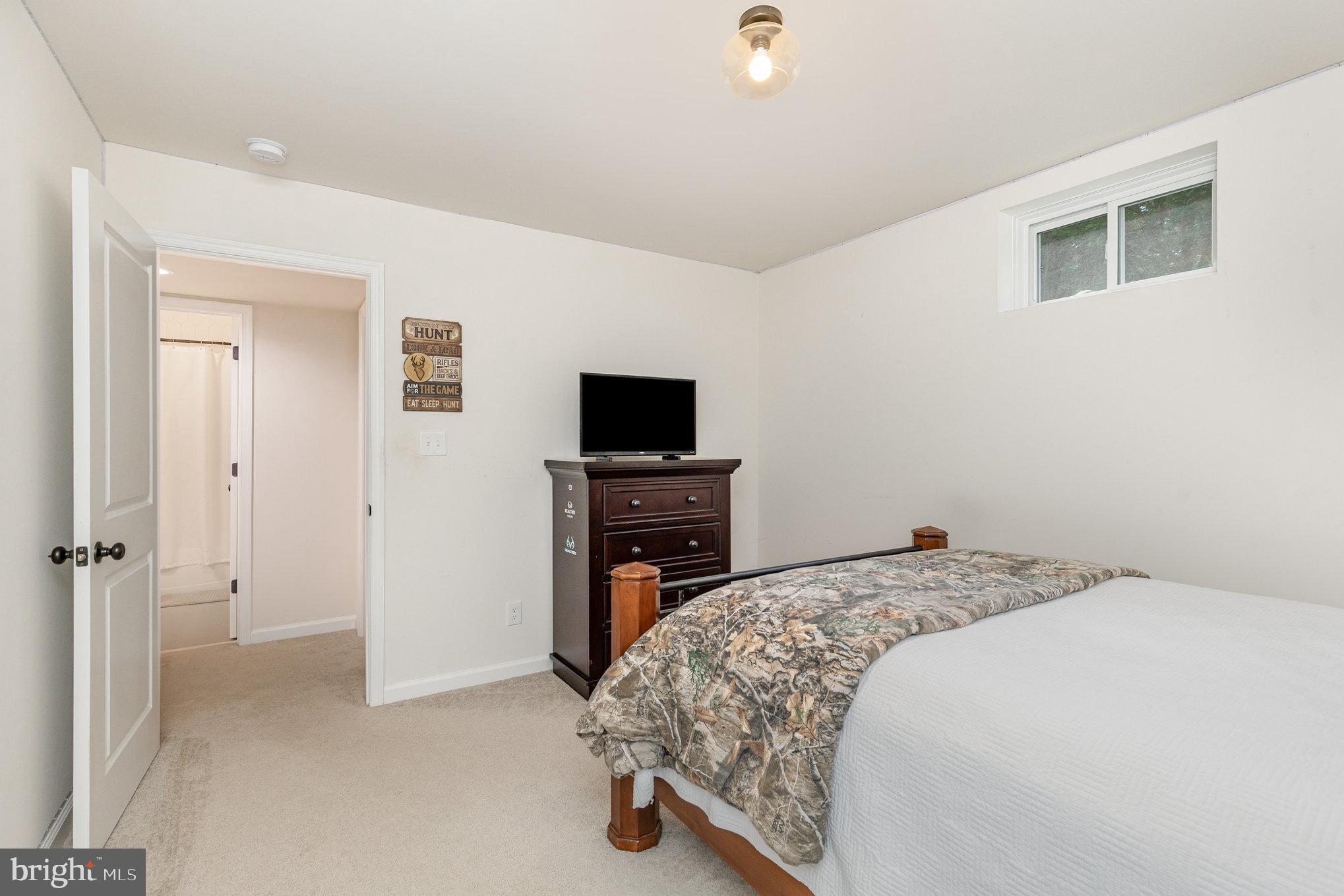 5224 Pendleton Farm Road Bumpass, VA 23024 - Photo 27 of 31 a bedroom with a bed and a flat screen tv