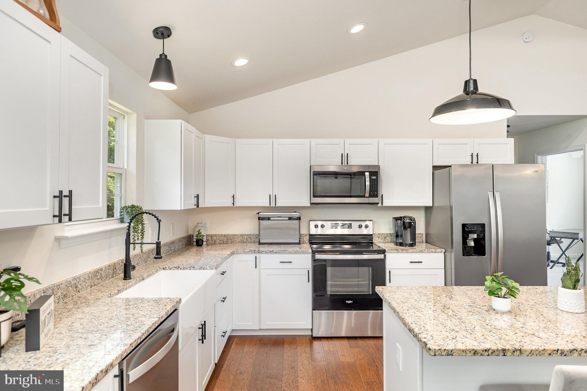 5224 Pendleton Farm Road Bumpass, VA 23024 - Photo 9 of 31 a kitchen with stainless steel appliances granite countertop a sink a stove a refrigerator cabinets and chairs