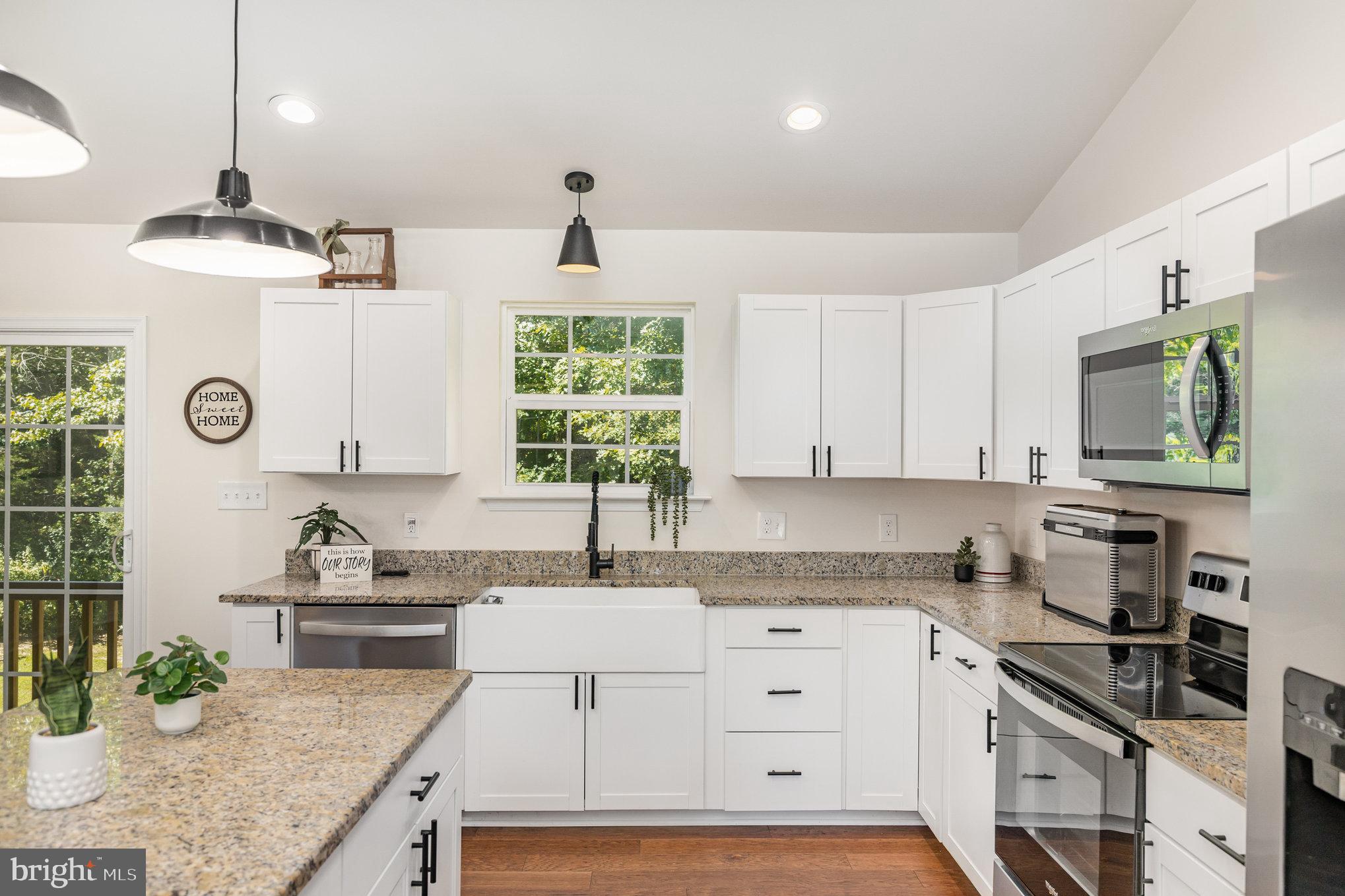 5224 Pendleton Farm Road Bumpass, VA 23024 - Photo 10 of 31 a kitchen with granite countertop a sink stainless steel appliances and cabinets