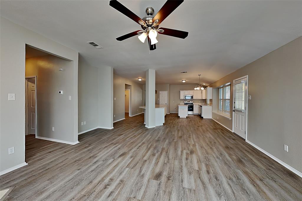 7016 Raintree Way Denton, TX 76210 - Photo 3 of 18 a living room with furniture and a wooden floor