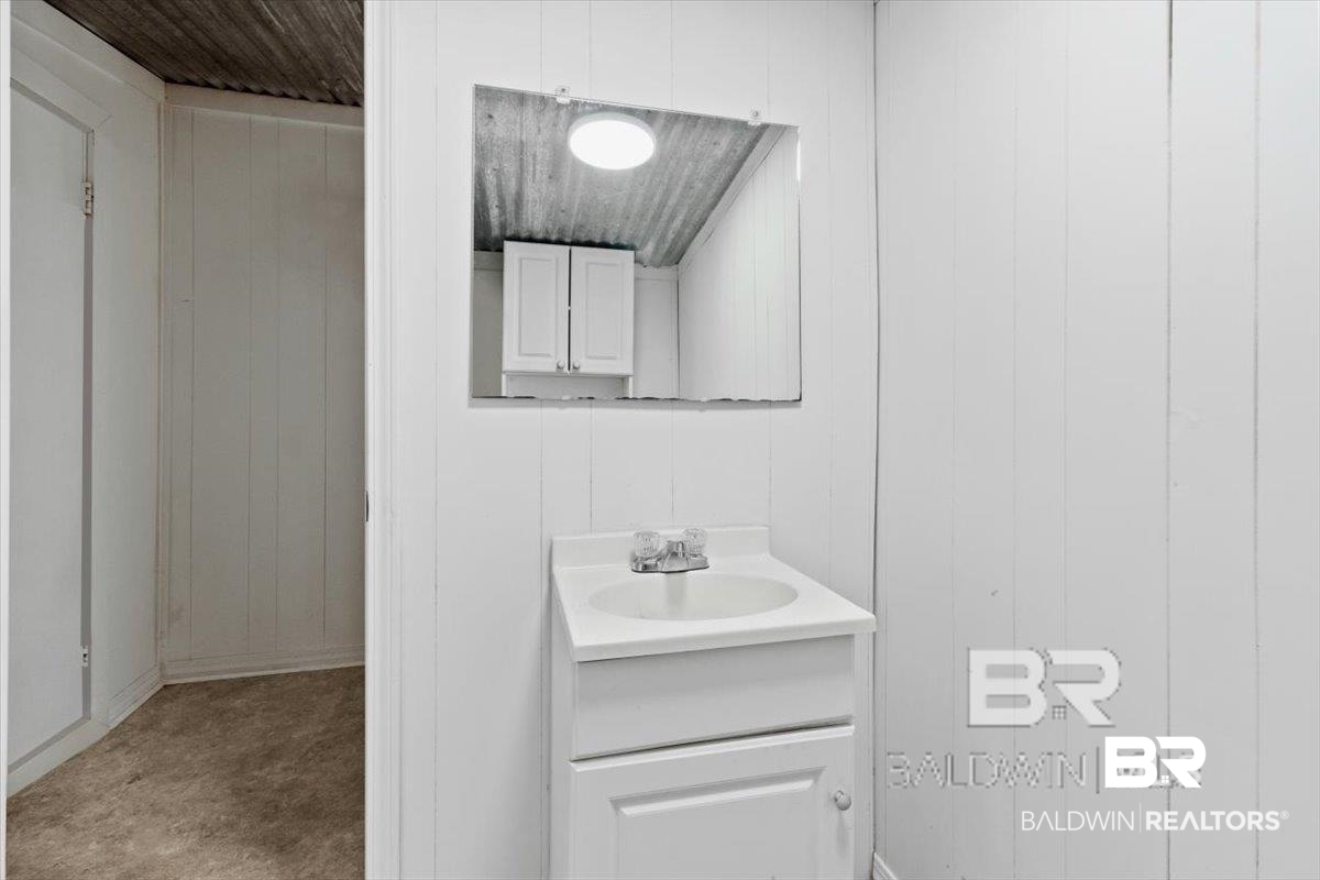 29397 Loper Road Loxley, AL 36551 - Photo 17 of 22 Half bath with vanity and wooden walls