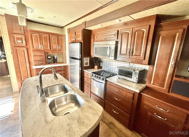 a kitchen with a sink appliances and cabinets