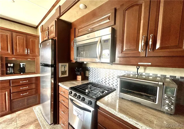 a kitchen with granite countertop a stove and a sink