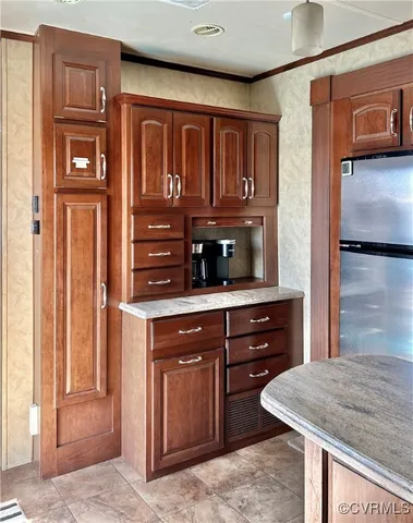 a kitchen with a wooden cabinets and a refrigerator