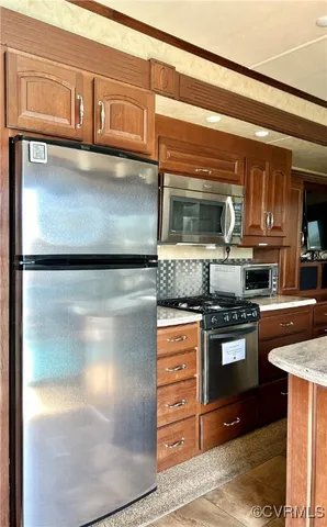 a kitchen with stainless steel appliances granite countertop a stove and a refrigerator