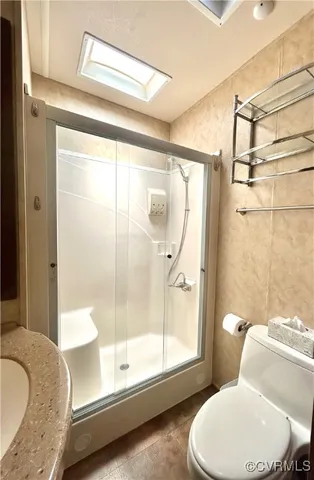 a bathroom with a granite countertop tub toilet and sink