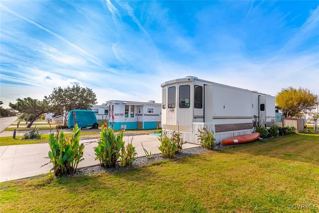 a front view of house with a garden and deck