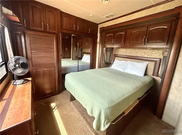 a bed sitting in a room next to a window