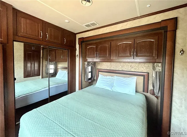 a bedroom with a large bed and a large window