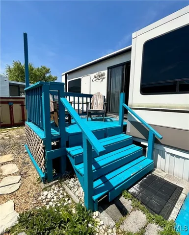 a view of backyard with deck and outdoor seating