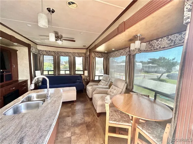 a large hall with dining table and sofas