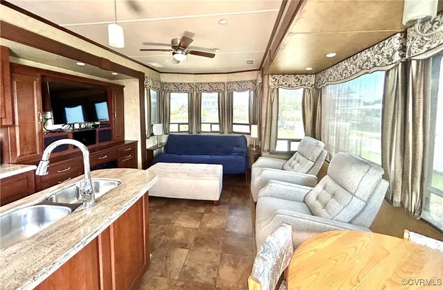 a large living room with granite countertop a couch and a large window