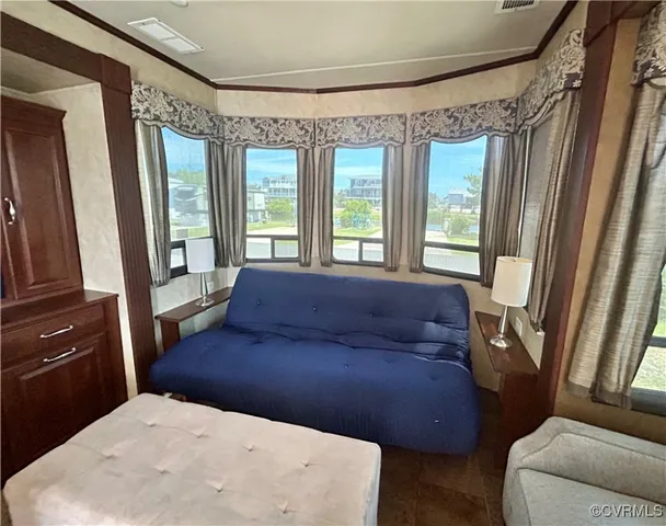 a large bed sitting in a bedroom next to a window