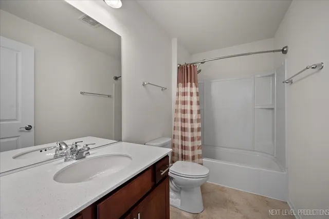 a white toilet sitting next to a bathroom sink