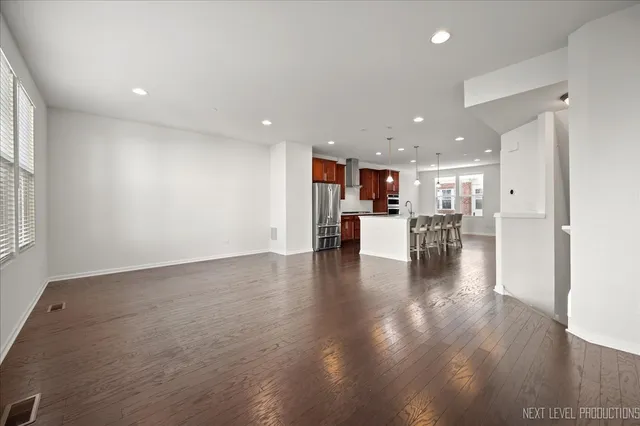 a view of kitchen and dining room with wooden floor