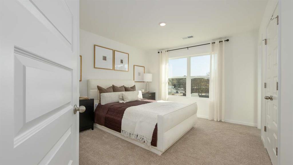 687 Alburgh Alley Mableton, GA 30126 - Photo 23 of 37 a spacious bedroom with a bed and a window