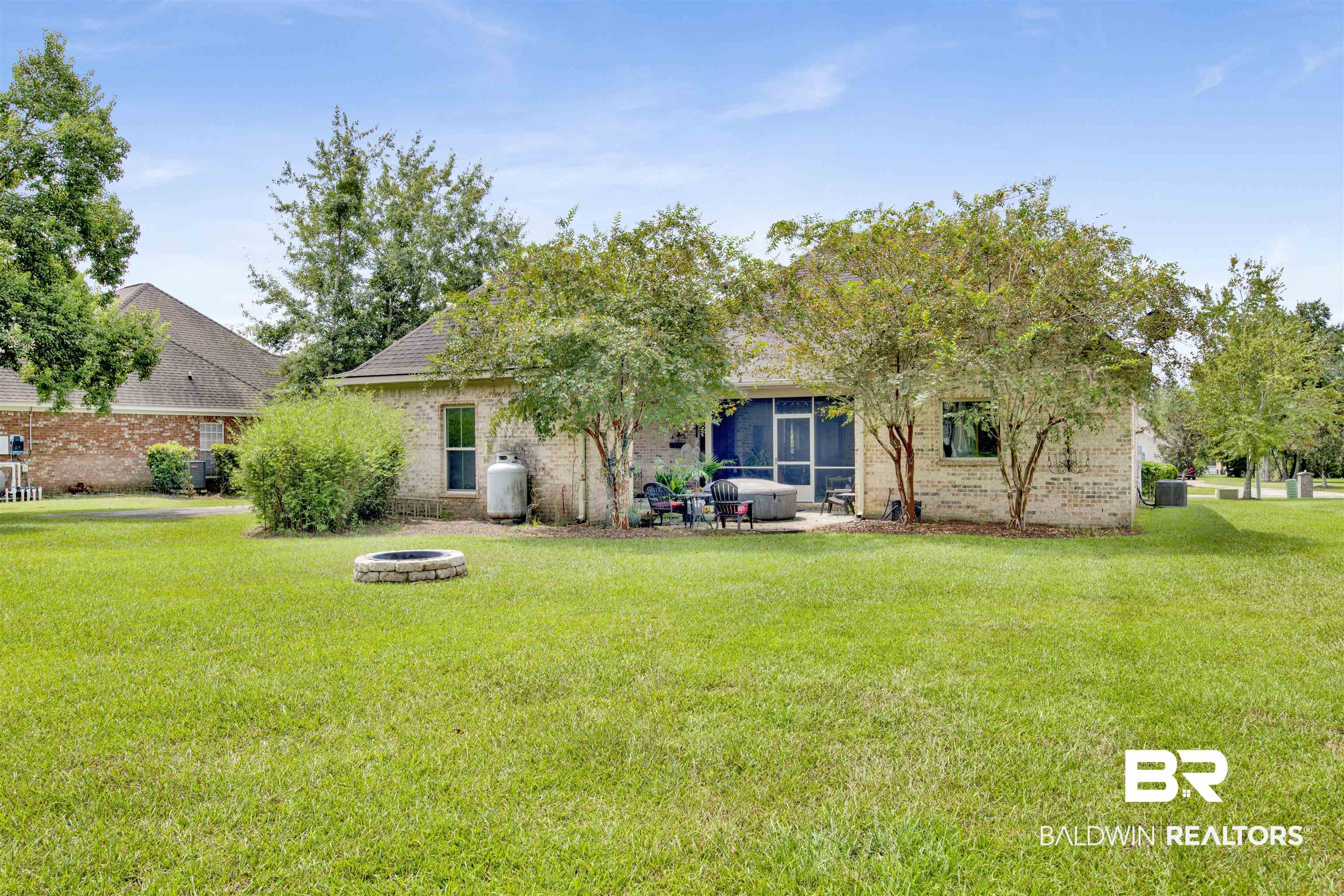 9240 Bay Point Drive Elberta, AL 36530 - Photo 4 of 22 Rear view of property featuring a yard and a fire pit