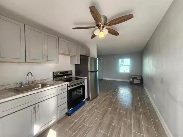 a kitchen with a sink stainless steel appliances and cabinets