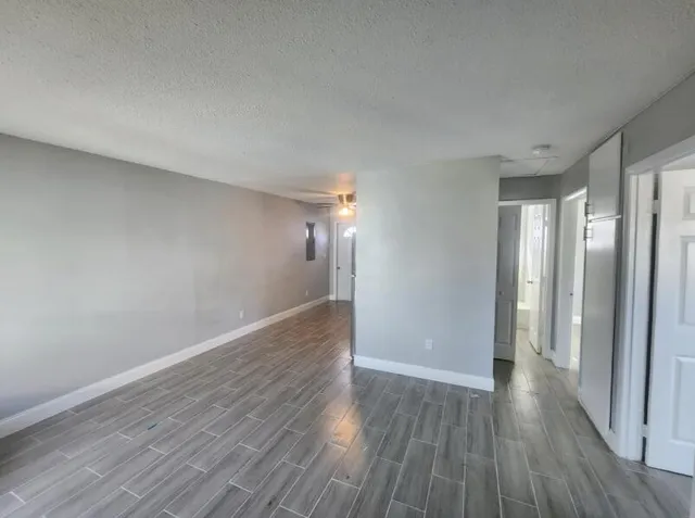 a view of a room with wooden floor