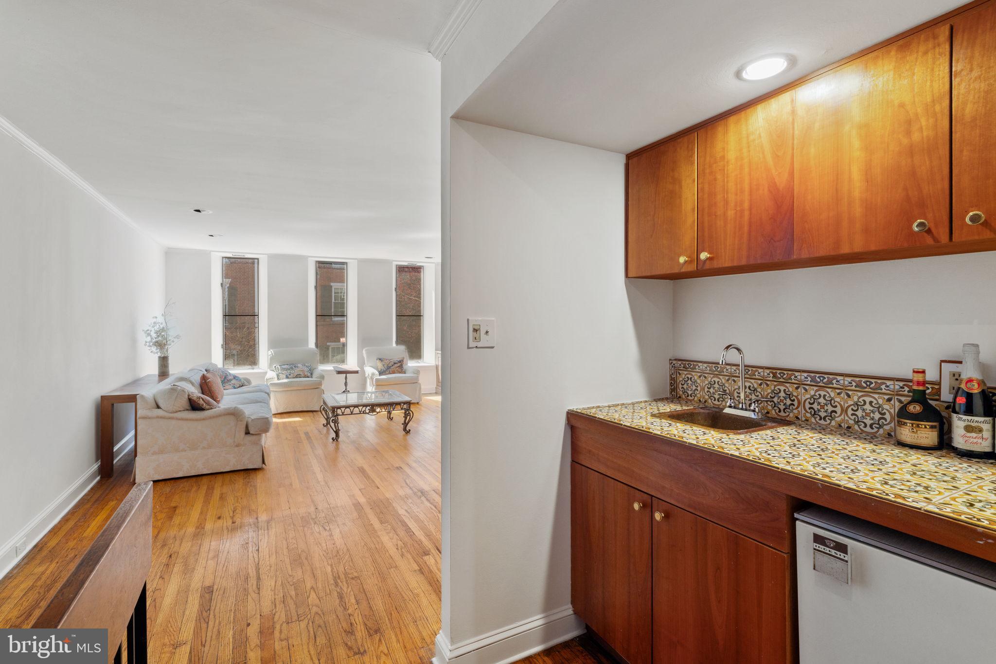 233 Monroe Street Philadelphia, PA 19147 - Photo 24 of 51 a kitchen with a sink and wooden cabinets