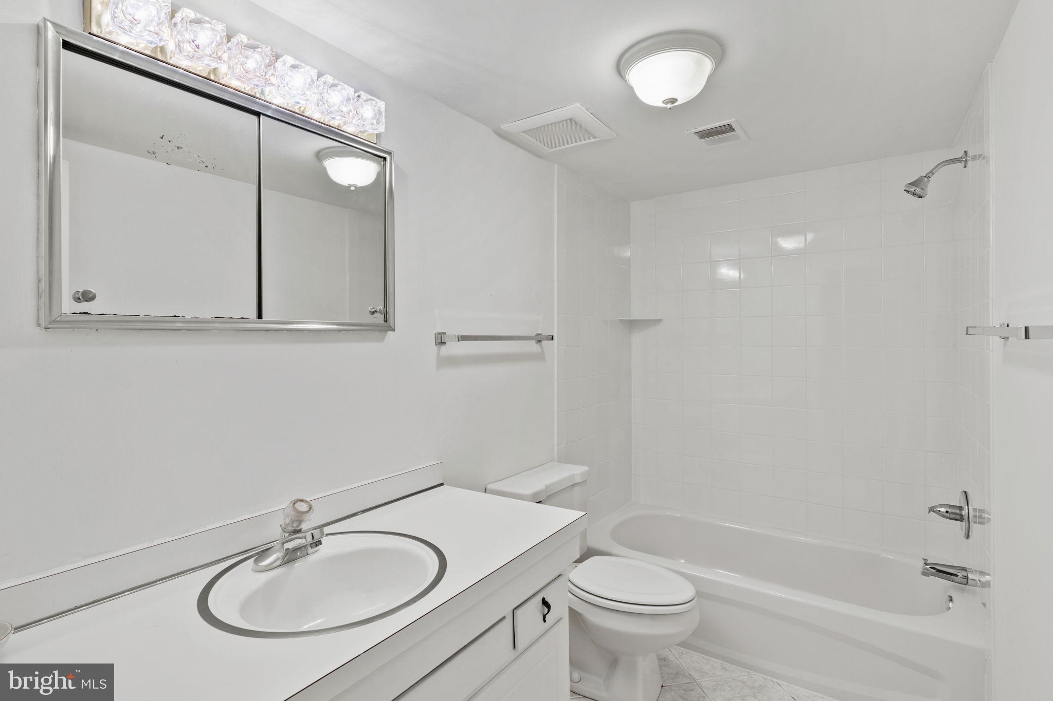 233 Monroe Street Philadelphia, PA 19147 - Photo 38 of 51 a bathroom with a sink toilet a mirror and shower