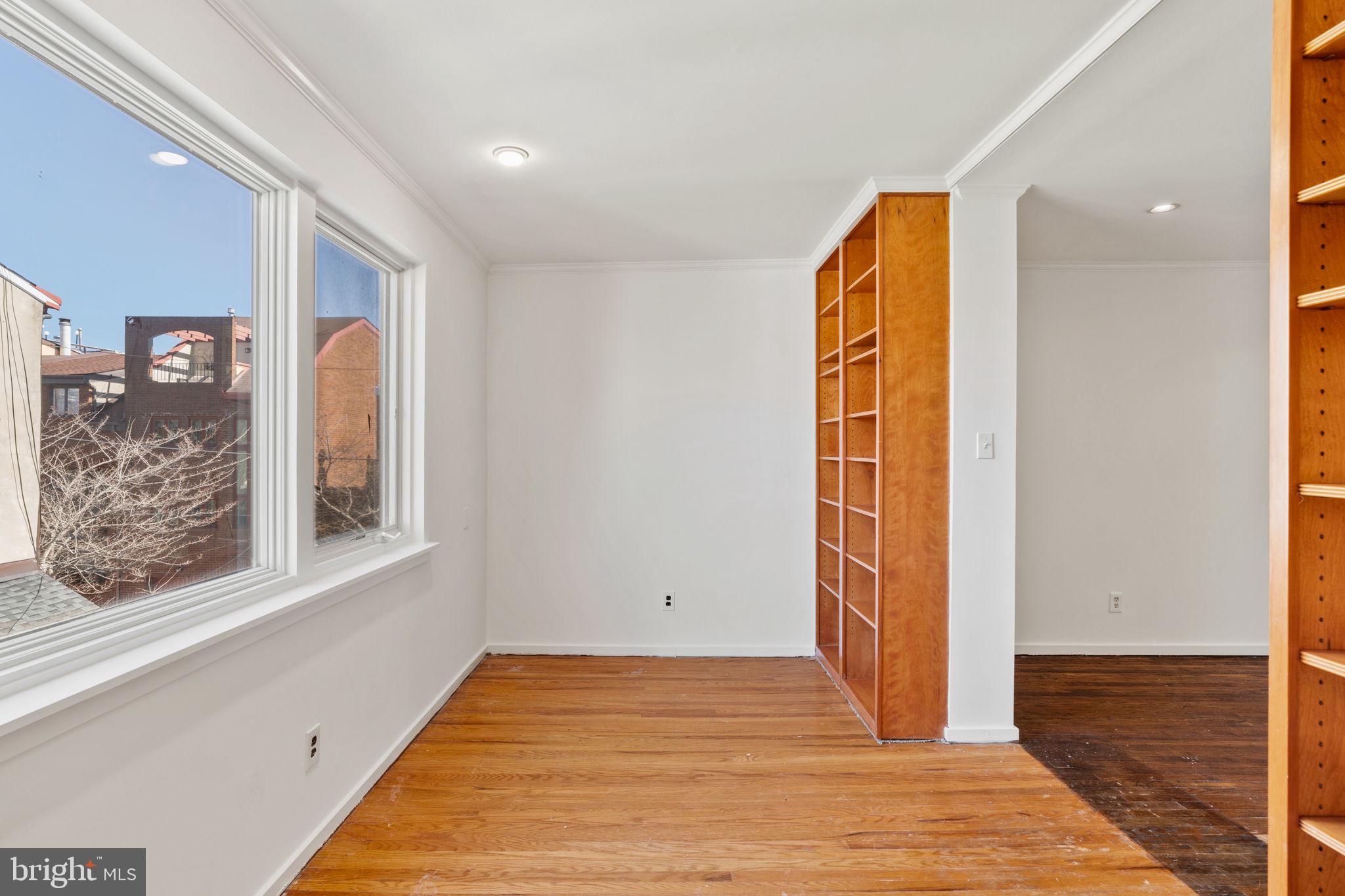 233 Monroe Street Philadelphia, PA 19147 - Photo 42 of 51 a view of an empty room with wooden floor and a window