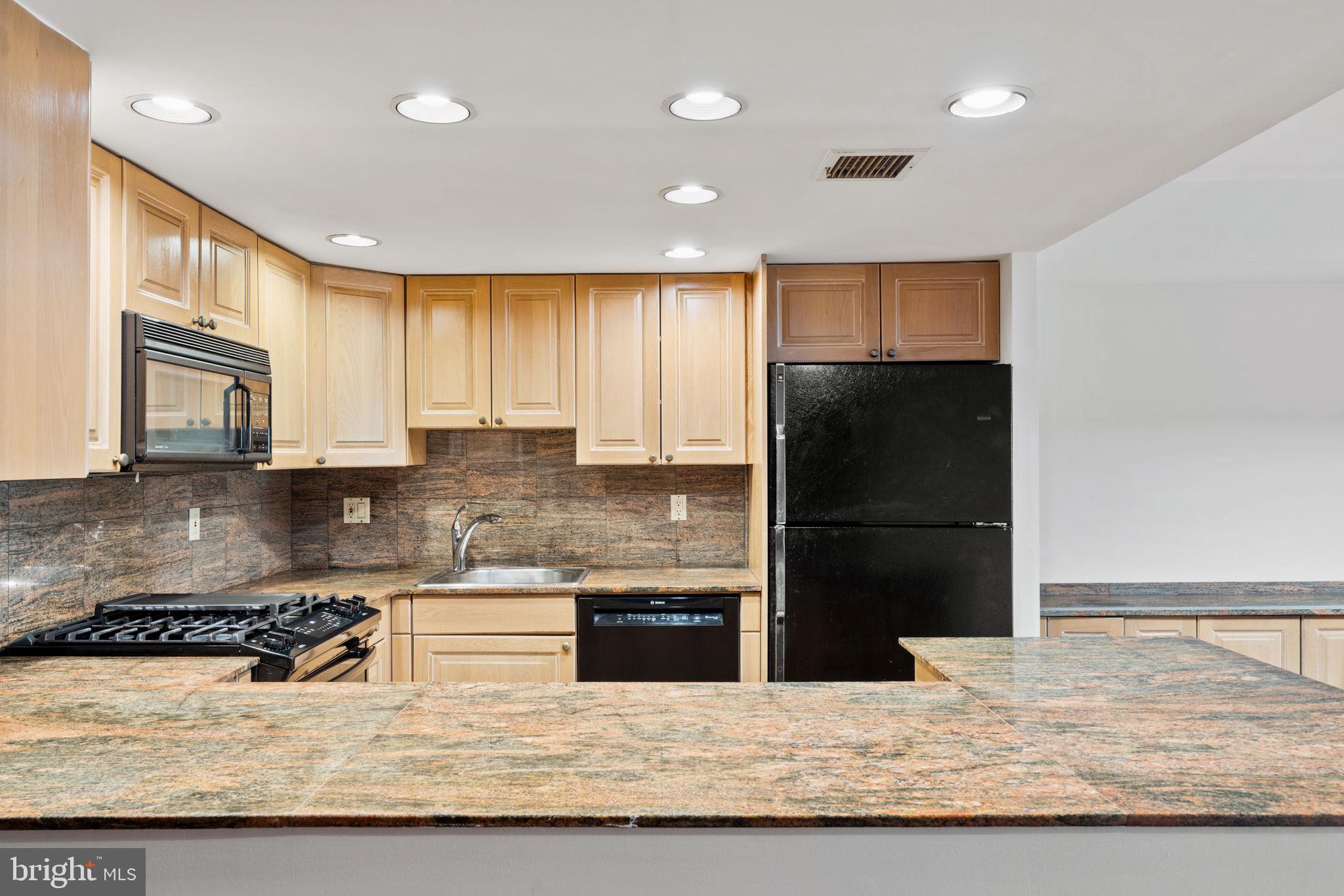 233 Monroe Street Philadelphia, PA 19147 - Photo 9 of 51 a kitchen with stainless steel appliances granite countertop a refrigerator stove microwave and sink