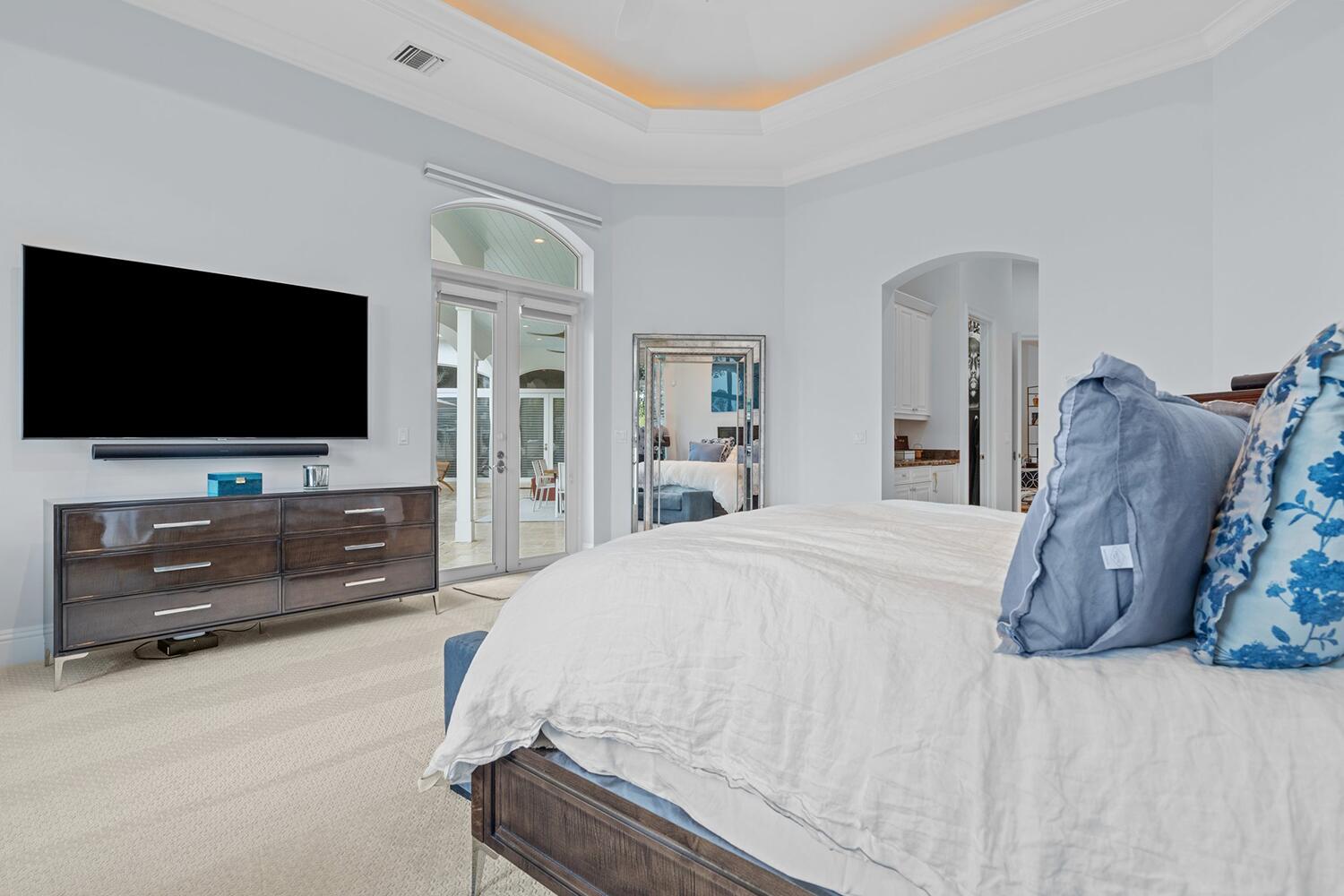 750 Northeast 37th Street Boca Raton, FL 33431 - Photo 16 of 50 a spacious bedroom with a bed and a flat screen tv