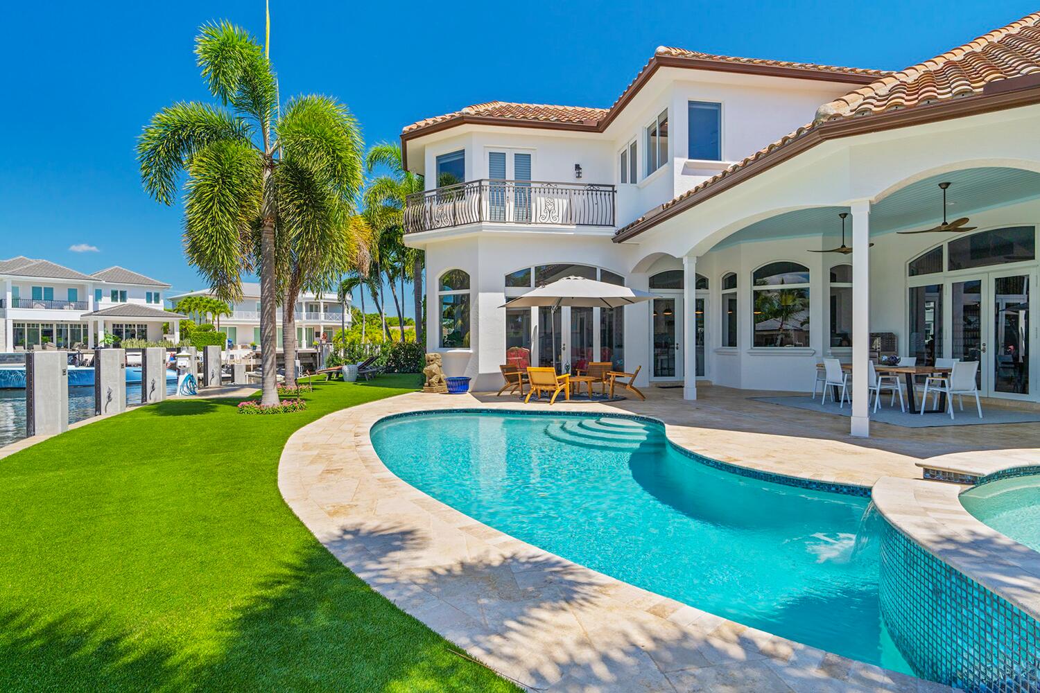 750 Northeast 37th Street Boca Raton, FL 33431 - Photo 3 of 50 front view of a house with swimming pool and porch