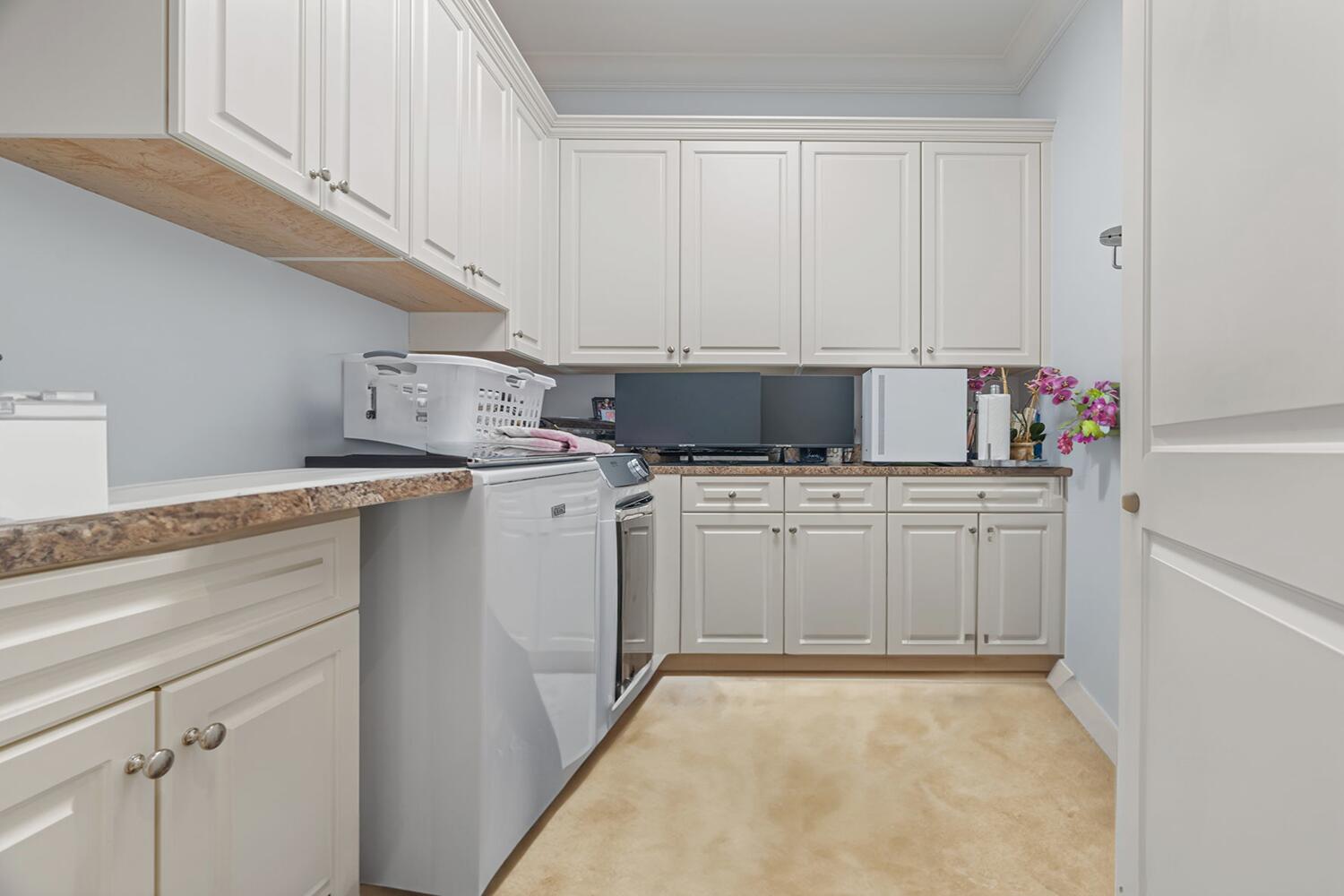 750 Northeast 37th Street Boca Raton, FL 33431 - Photo 35 of 50 a utility room with cabinets washer and dryer