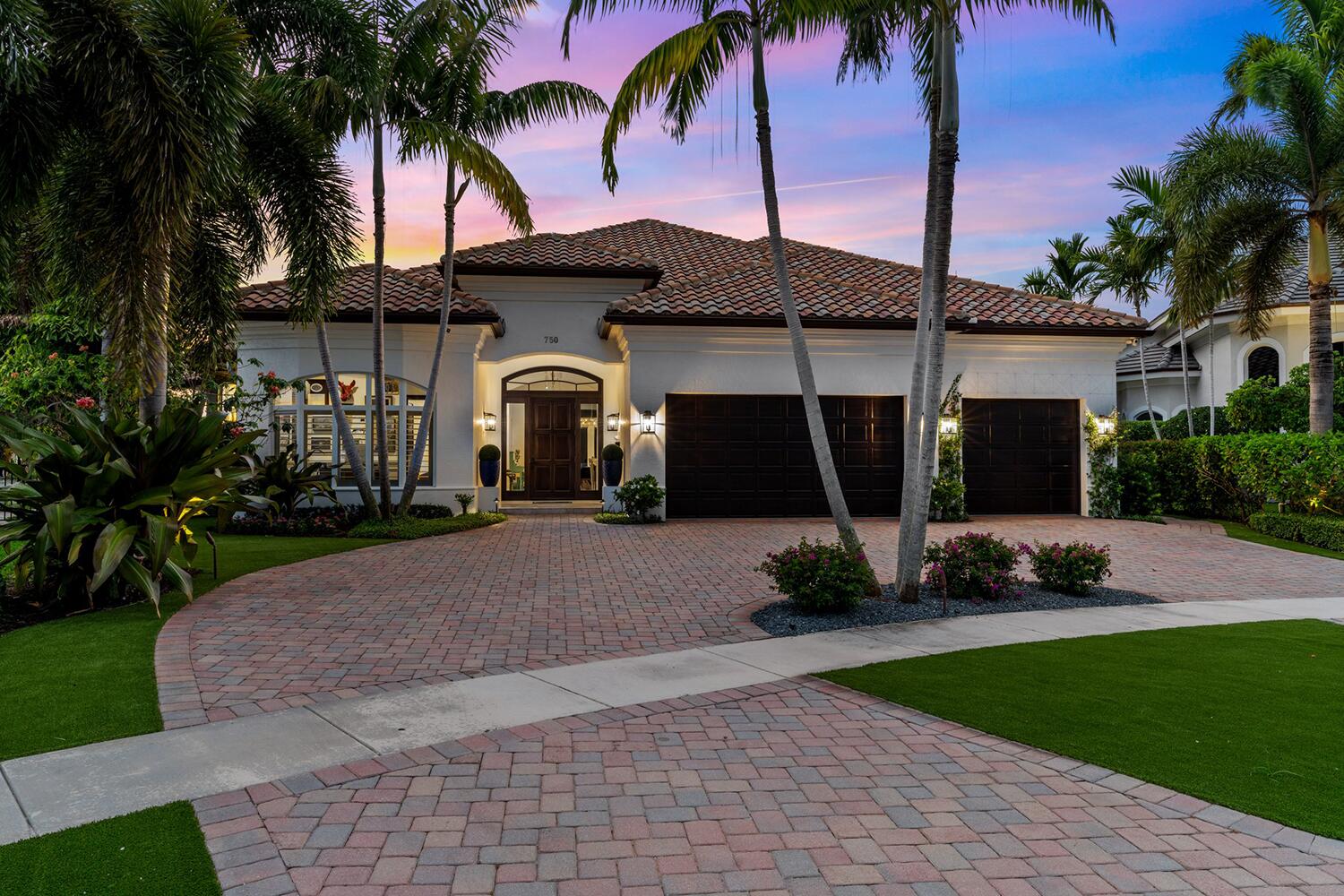 750 Northeast 37th Street Boca Raton, FL 33431 - Photo 4 of 50 a front view of a house with a garden and trees