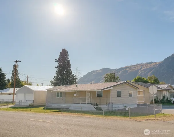 a view of house with garden and tall trees