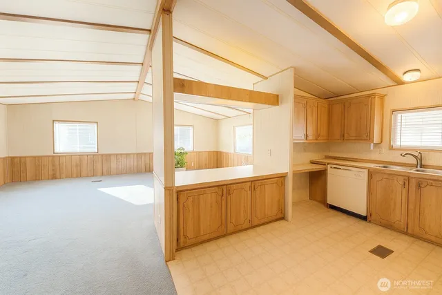 a large white kitchen with a sink