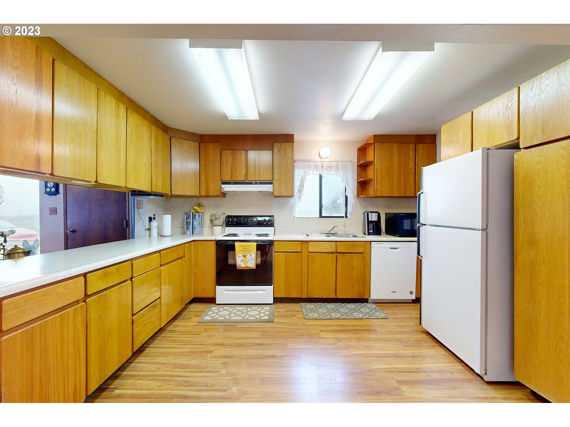 55478 Stateline Road Milton Freewater, OR 97862 - Photo 13 of 26 a kitchen with granite countertop a refrigerator cabinets stainless steel appliances and a center island