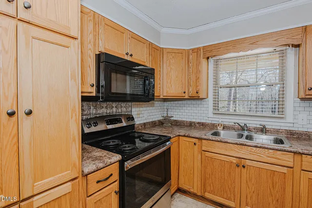 a kitchen with a stove microwave and sink