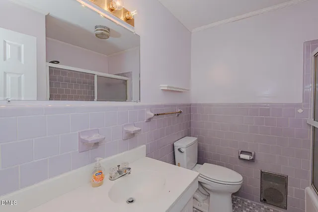 a white bath tub sitting next to a white toilet