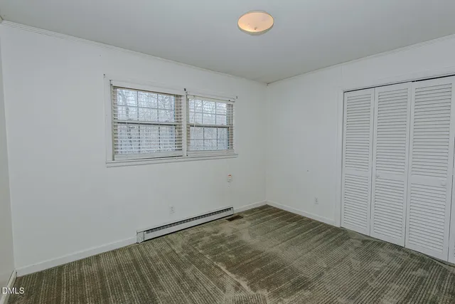 an empty room with a empty space and window