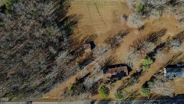 a view of a dry yard with lots of green space
