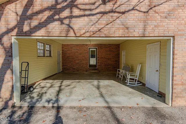 a backyard of a house with table and chairs