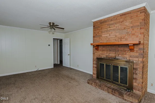 a view of empty room with fireplace
