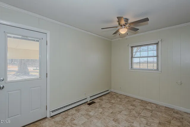 an empty room with a window and a fan